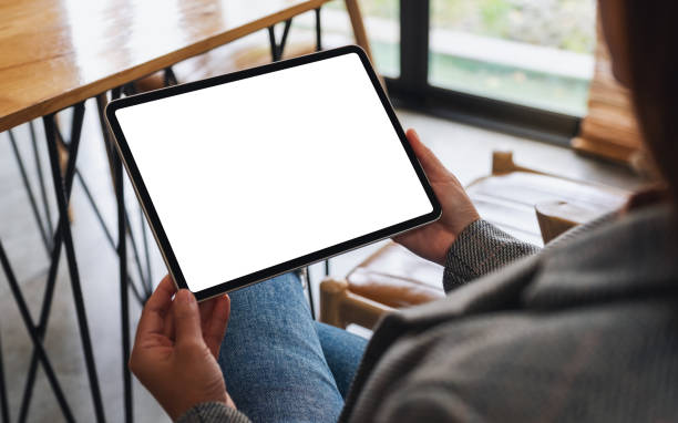 istock a woman holding digital tablet with blank white desktop screen 1285585401