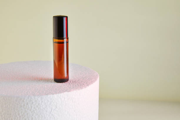 istock Dropper Bottle - Amber Glass for unlabelled perfume bottles on white podium 1285586463