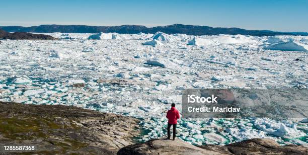 Travel In Arctic Landscape Nature With Icebergs Greenland Tourist Man Explorer Stock Photo - Download Image Now