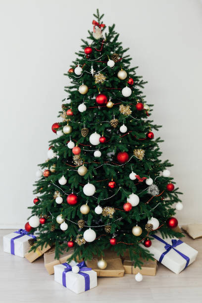 istock Christmas tree pine with gifts interior decor new year 1285589172