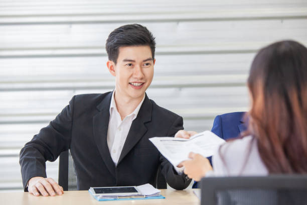 istock Business manager give papers presenting document report business plan to team people at corporate meeting 1285589191