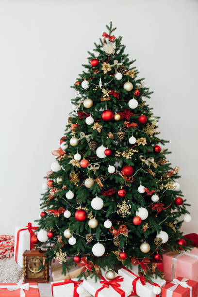 istock Christmas tree pine with gifts interior decor new year 1285589247