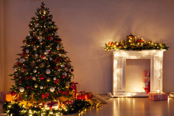istock Christmas tree pine with gifts light garlands interior decor new year 1285589304
