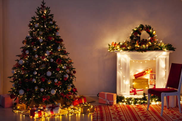 istock Christmas tree pine with gifts light garlands interior decor new year 1285589322