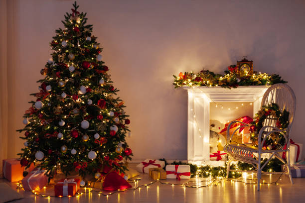 istock Christmas tree pine with gifts light garlands interior decor new year 1285589359