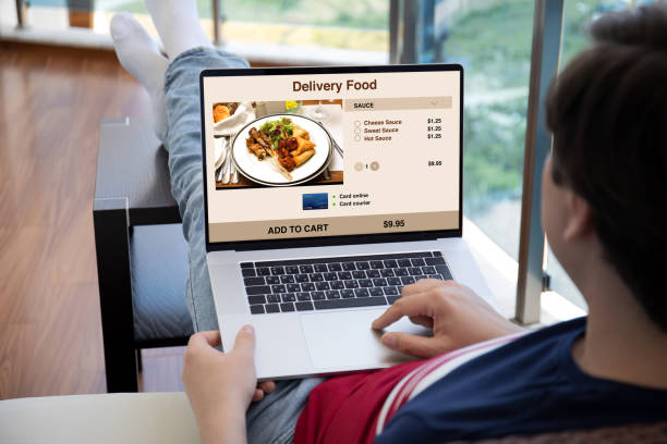 istock man holds laptop with food delivery application on the screen 1285590069