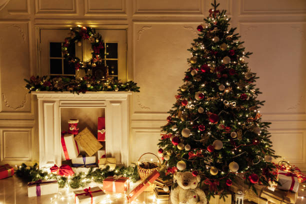 istock Light garland Christmas tree decor presents new year night interior 1285590370