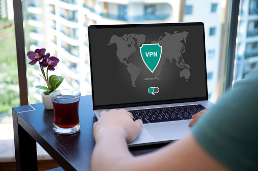 man uses app vpn creation Internet protocols for protection private network on screen computer laptop