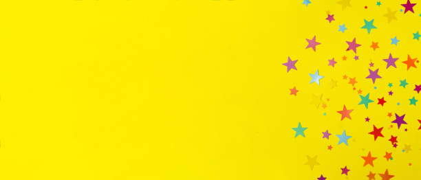 istock multicolored backdrop of colored stars confetti on a yellow background 1285593438
