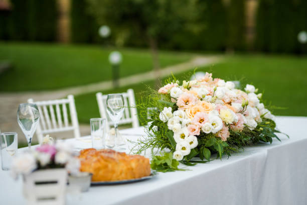 istock Wedding table set up. Outdoor table set up - wedding/party table with fresh flowers. 1285596344