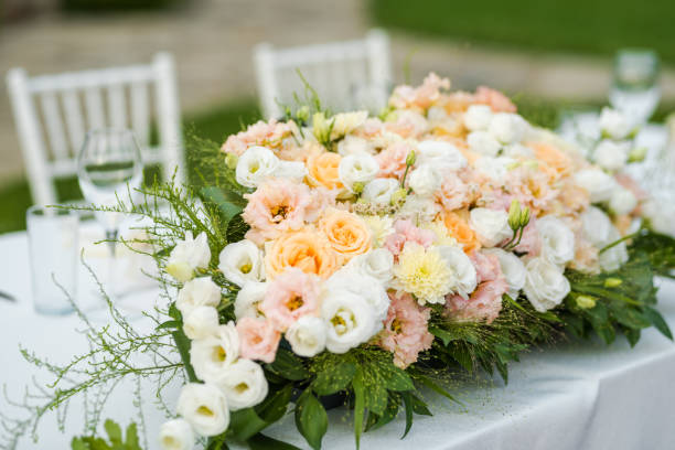 istock Wedding table set up. Outdoor table set up - wedding/party table with fresh flowers. 1285596348