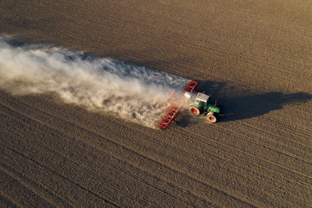istock Tractor Sowing in Field, Aerial View 1285596400