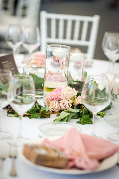 istock Luxury wedding table decoration in pink and white. Special event table set up. Fresh flower decoration. 1285597045