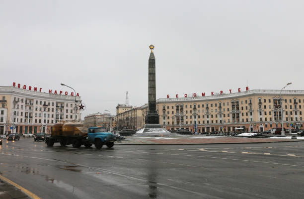 Main Square in Minsk A truck thunders around the roundabout on Victory Square in Minsk, Belarus. January 2018 minsk stock pictures, royalty-free photos & images