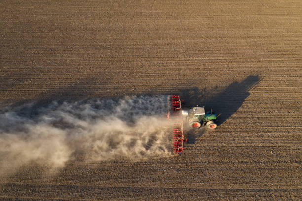istock Farm Tractor Drilling Seed In Plowed Field 1285597162