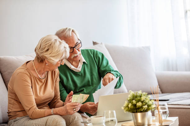 istock Senior couple brainstorming the solution to a financial problem 1285597419