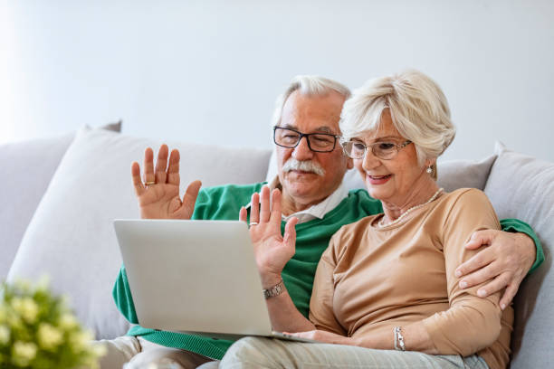 istock Happy senior couple having video call on laptop. 1285597440