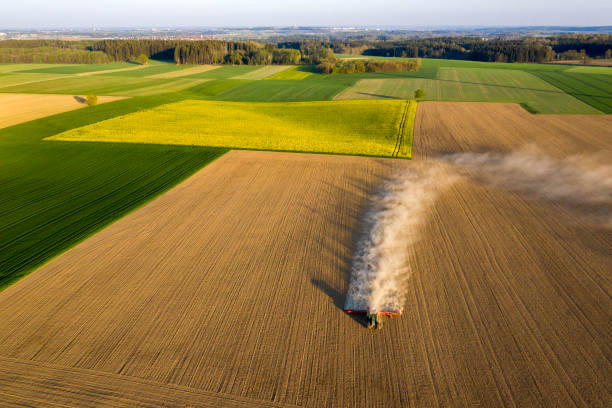 istock Aerial view of a tractor sowing plowed field 1285597547