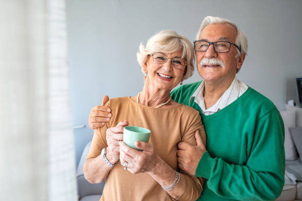 istock Happy pensioner couple enjoying time at home 1285598122