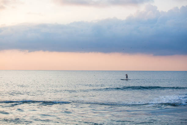 istock Sapboarder floats on the sea in Sochi, Russia 1285599409