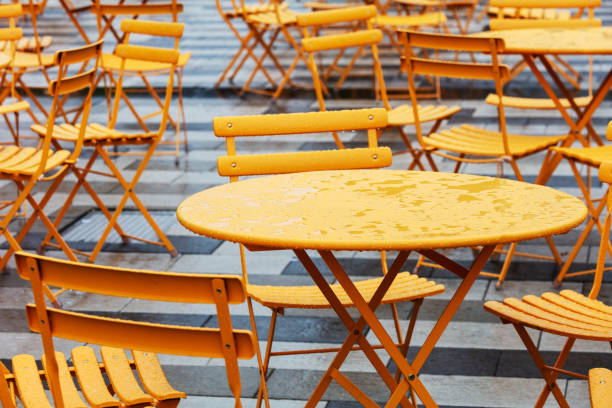 tables and chairs in a cafe on the street