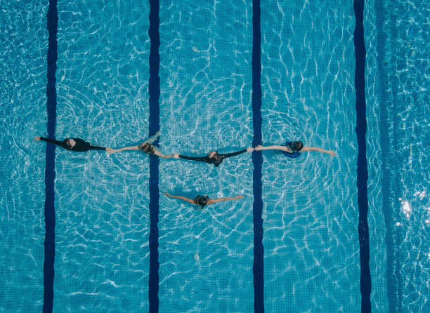 istock drone point of view directly above swimming pool coach instructor teaching her student swimming skill 1285601602