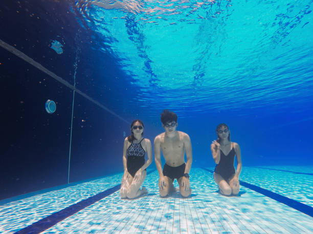 istock asian chinese coach guiding his student underwater breathing exercise in swimming pool 1285602464