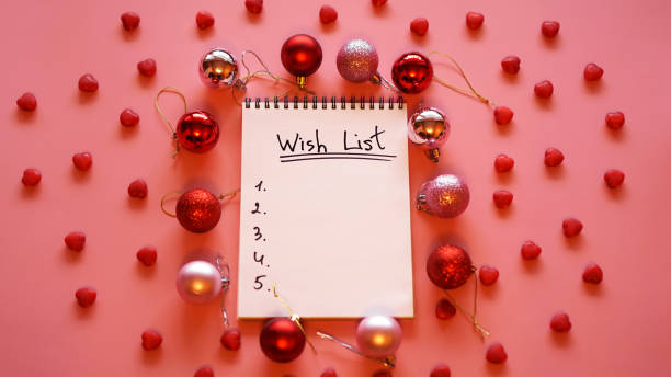 istock Notebook on pink background with christmas balls 1285602477