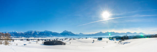 istock panoramic landscape at winter with alps mountains in Bavaria 1285602676