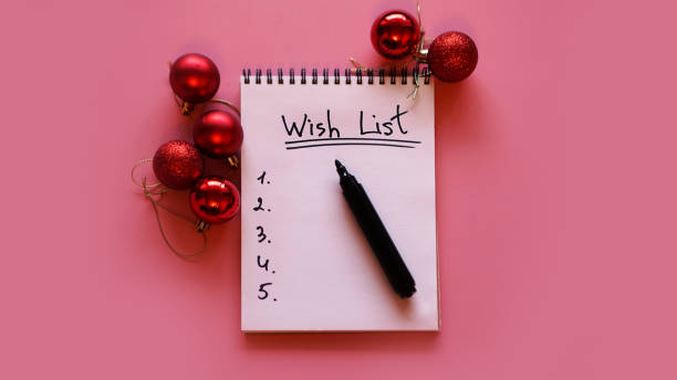 istock Notebook on pink background with christmas balls 1285602682