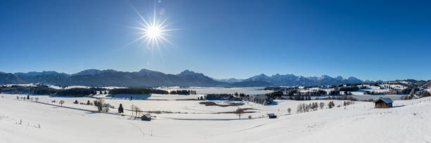 istock panoramic landscape at winter with alps mountains in Bavaria 1285603790