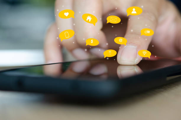 istock Hand holding  smartphone with icons concept. 1285603873