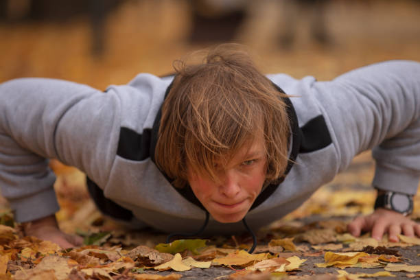 istock Man pushups outdoor at the autumn park 1285604055