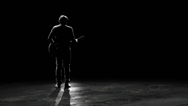 istock Old guitarist performing on stage with his guitar view from back 3d rendering 1285604351