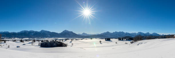istock panoramic landscape at winter with alps mountains in Bavaria 1285605172