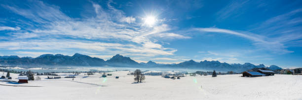 istock panoramic landscape at winter with alps mountains in Bavaria 1285606315