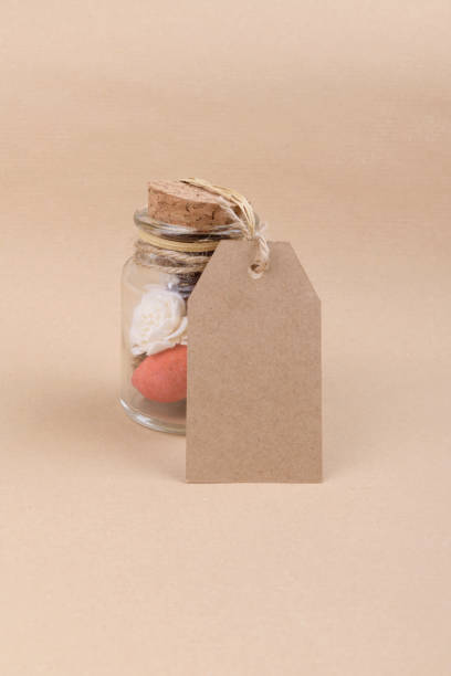istock a glass jars with dried herbs for aromatherapy with empty rectungolar tag on craft paper backrgound 1285607127