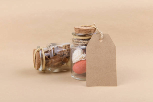 istock Two glass jars with dried herbs for aromatherapy with empty rectungolar tag on craft paper backrgound 1285607130