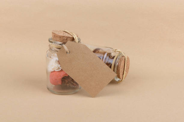 istock Two glass jars with dried herbs for aromatherapy with empty rectungolar tag on craft paper backrgound 1285607133