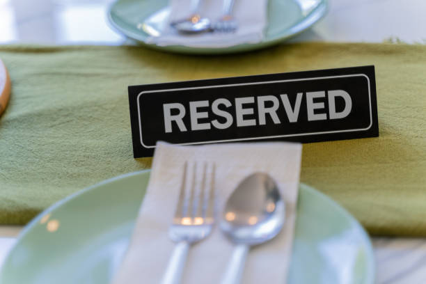 istock Close up of a reserved sign on a dining table in a restaurant 1285607179