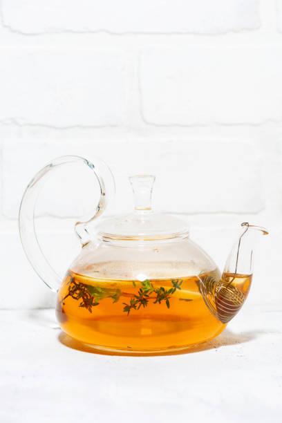 istock flavored black tea with thyme in a glass teapot, vertical 1285608386