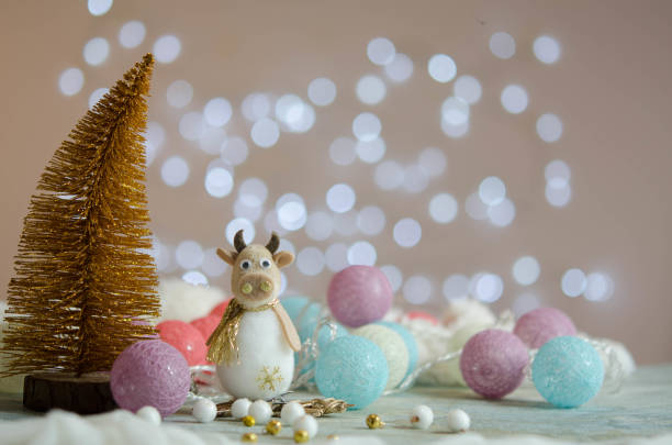istock New Year's composition. Christmas balls. Bokeh. Toy bull. 1285609635