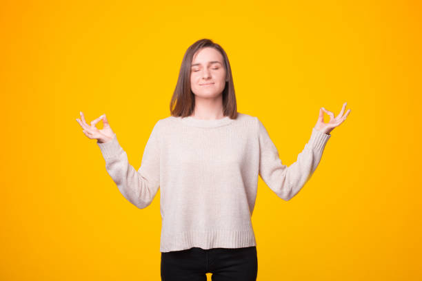 istock A calm happy woman is sitting in a zen posture 1285609725