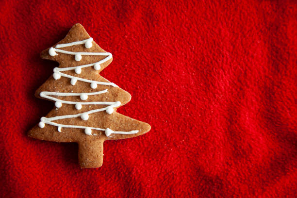 Tree  shaped cookies for Christmas onred fabric background.