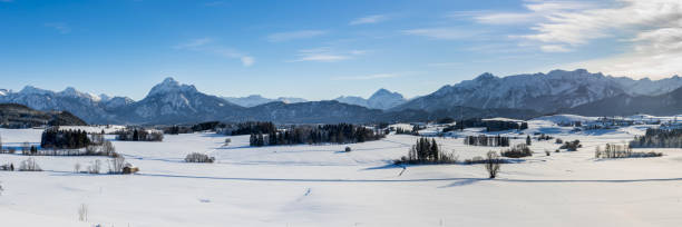 istock panoramic landscape at winter with alps mountains in Bavaria 1285614059