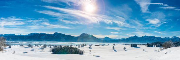 istock panoramic landscape at winter with alps mountains in Bavaria 1285614704