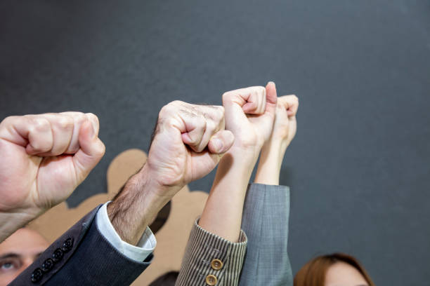 istock Competition and teamwork concepts, People raise fists. office workers teamwork concept 1285615184