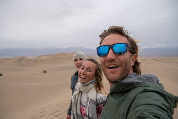 istock Friends take selfie on sand dunes 1285616221