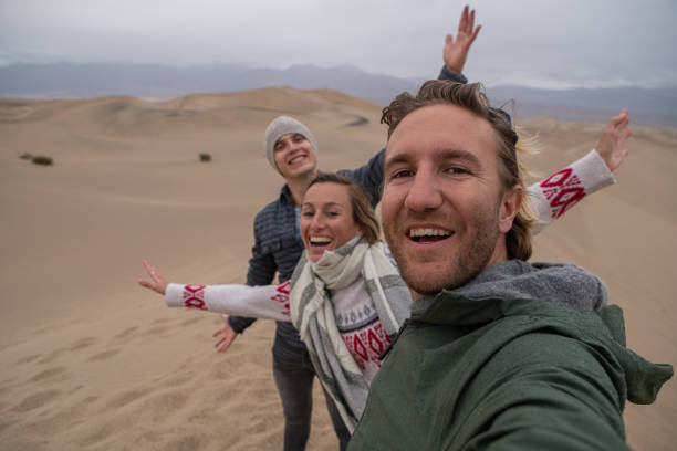 istock Friends take selfie on sand dunes 1285617228