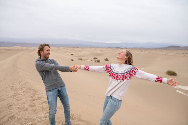 istock Couple plays on the sand dunes in USA 1285617687
